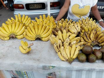 Midsection of woman with fruits at market