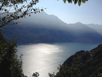 Scenic view of sea and mountains against sky