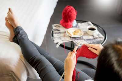 High angle view of woman knitting wool