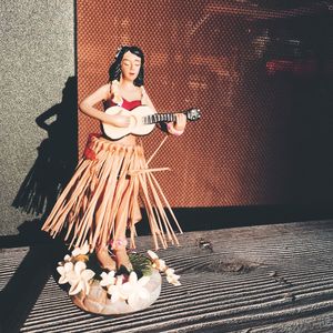 Full length portrait of woman standing against wall