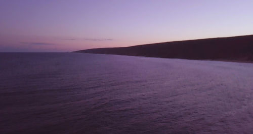 Scenic view of sea against clear sky at sunset