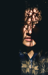 Close-up portrait of young woman looking away