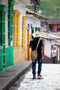 Local man wearing a traditional hat walking at the streets of concepcion in antioquia, colombia.