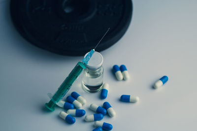 High angle view of pills on white background