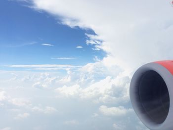 Cropped image of airplane flying over clouds