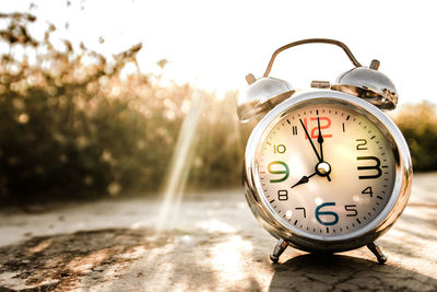 Close-up of alarm clock on footpath