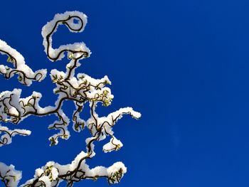 Low angle view of statue against clear blue sky