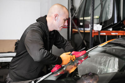 Side view of man working in bus