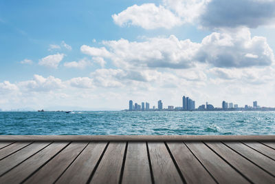 Scenic view of sea by city against sky