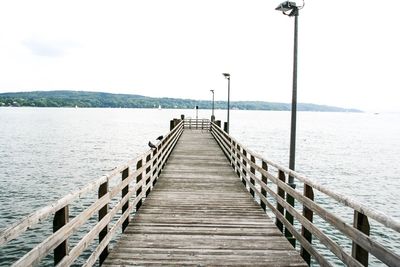 Pier over sea against sky