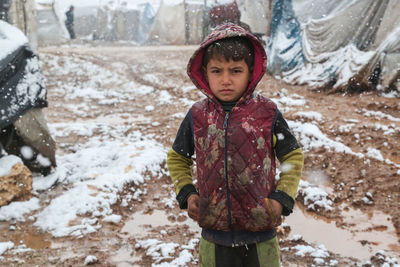 A refugee child during a snowfall on a syrian refugee camp near the turkish border.