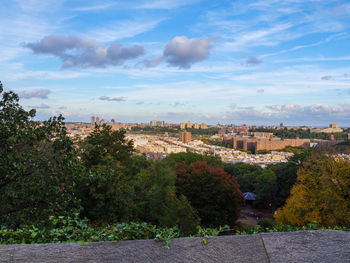 Trees and buildings against sky