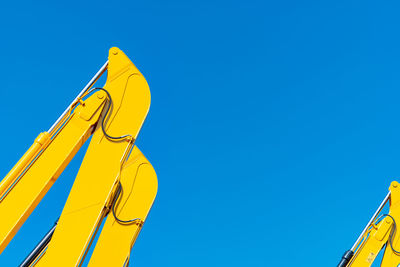 Low angle view of yellow pole against clear sky