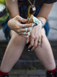 Midsection of woman holding ice cream cone