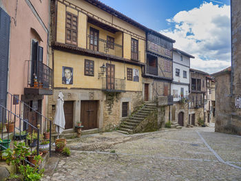 Street amidst buildings against sky