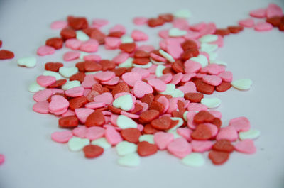 Small white, pink and red heart-shaped sweets to decorate a birthday cake