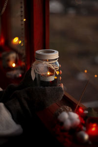 Person holding lit tea light candles