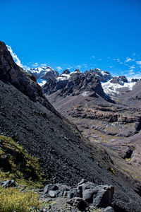 Scenic view of snowcapped mountains against blue sky