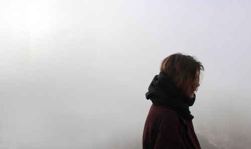 Rear view of girl standing against clear sky