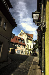 Street amidst buildings in city against sky