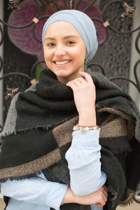 Portrait of smiling young woman wearing warm clothing in winter