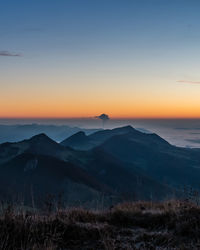 Scenic view of mountains against clear sky during sunset