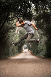 Full length of man jumping on road