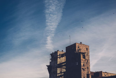 Low angle view of buildings against sky on sunny day