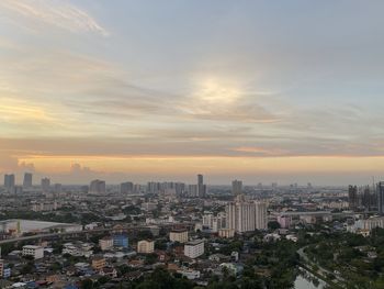 Aerial view of buildings in city during sunset