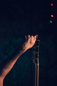 Close-up of hand by guitar during concert