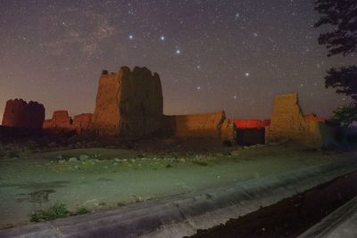 Scenic view of land against sky at night
