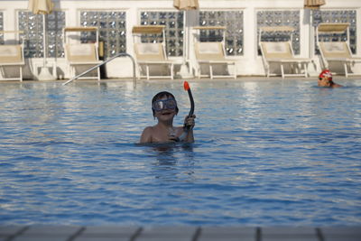 Portrait of child swimming in pool