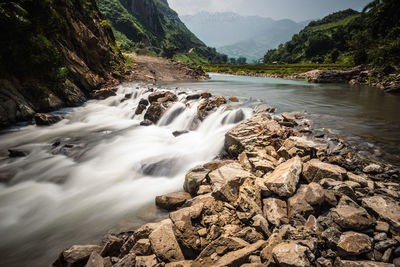 Scenic view of stream flowing through rocks