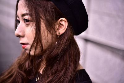 Close-up portrait of young woman looking away