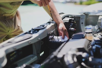 Midsection of man repairing car