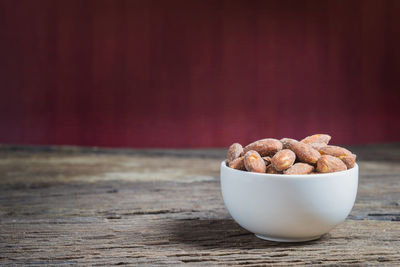 Close-up of salted almonds in bowl on table