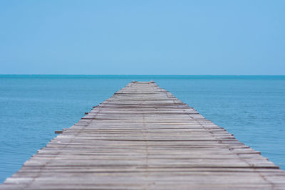 Pier over sea against clear sky