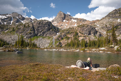 Scenic view of lake by mountains against sky