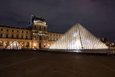 Low angle view of illuminated buildings at night