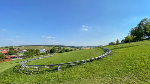Scenic view of land against sky with summer toboggan