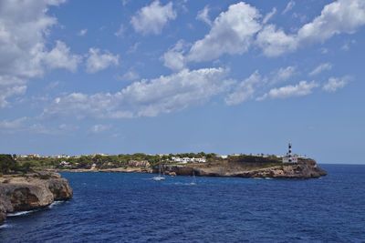 Scenic view of sea and buildings against sky