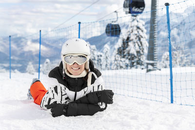 Woman skiing on snow covered field