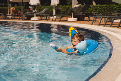 Portrait of boy swimming in pool