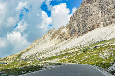 Road amidst rocks against sky