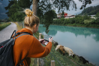 Woman taking photo with cell phone