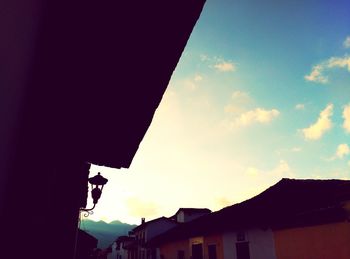 Low angle view of silhouette built structure against sky