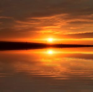 Scenic view of lake against romantic sky at sunset