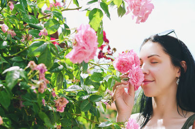 Close-up of young woman picking flowers