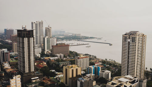 High angle view of buildings in city against sky