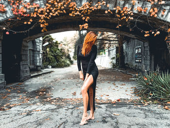 Woman standing by plants